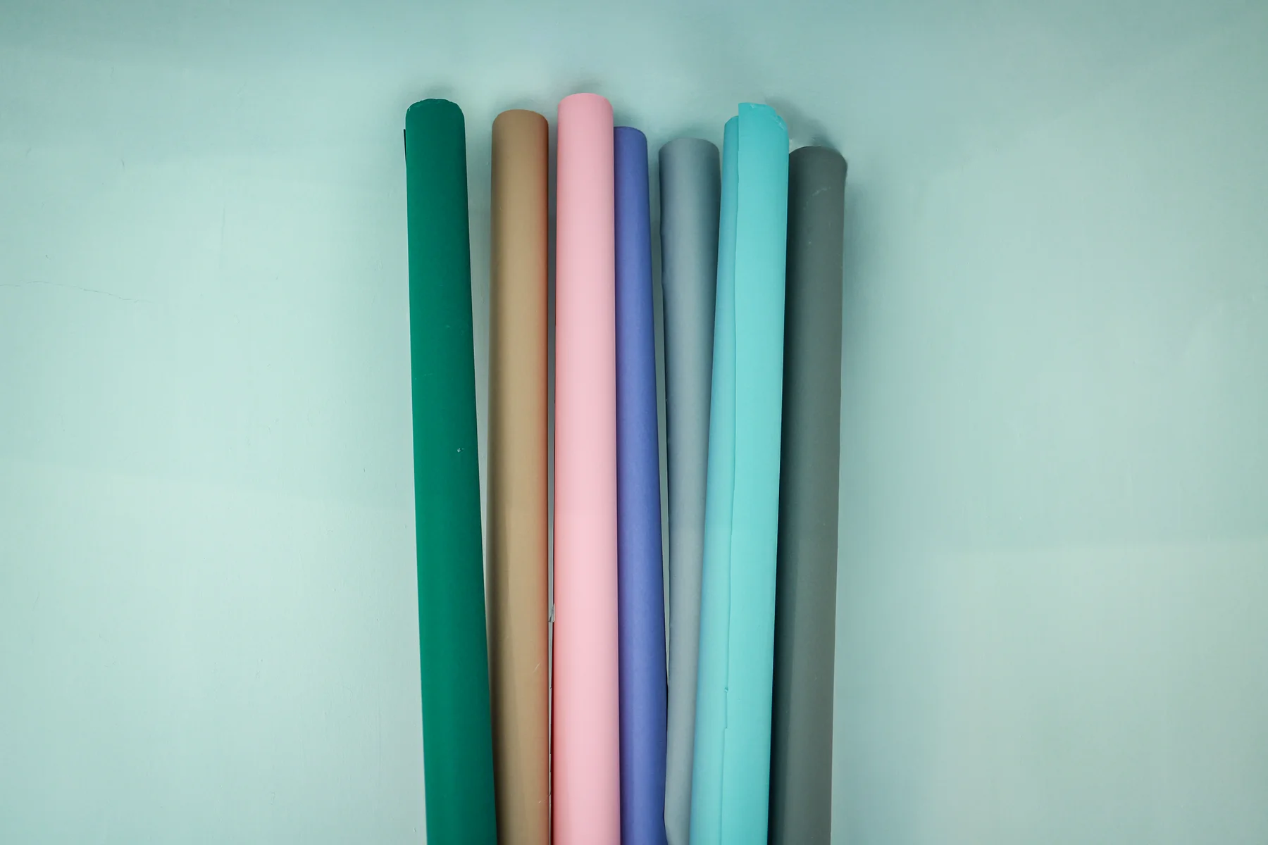 A selection of green, sand, blush, lavender, grey and aqua backdrop rolls