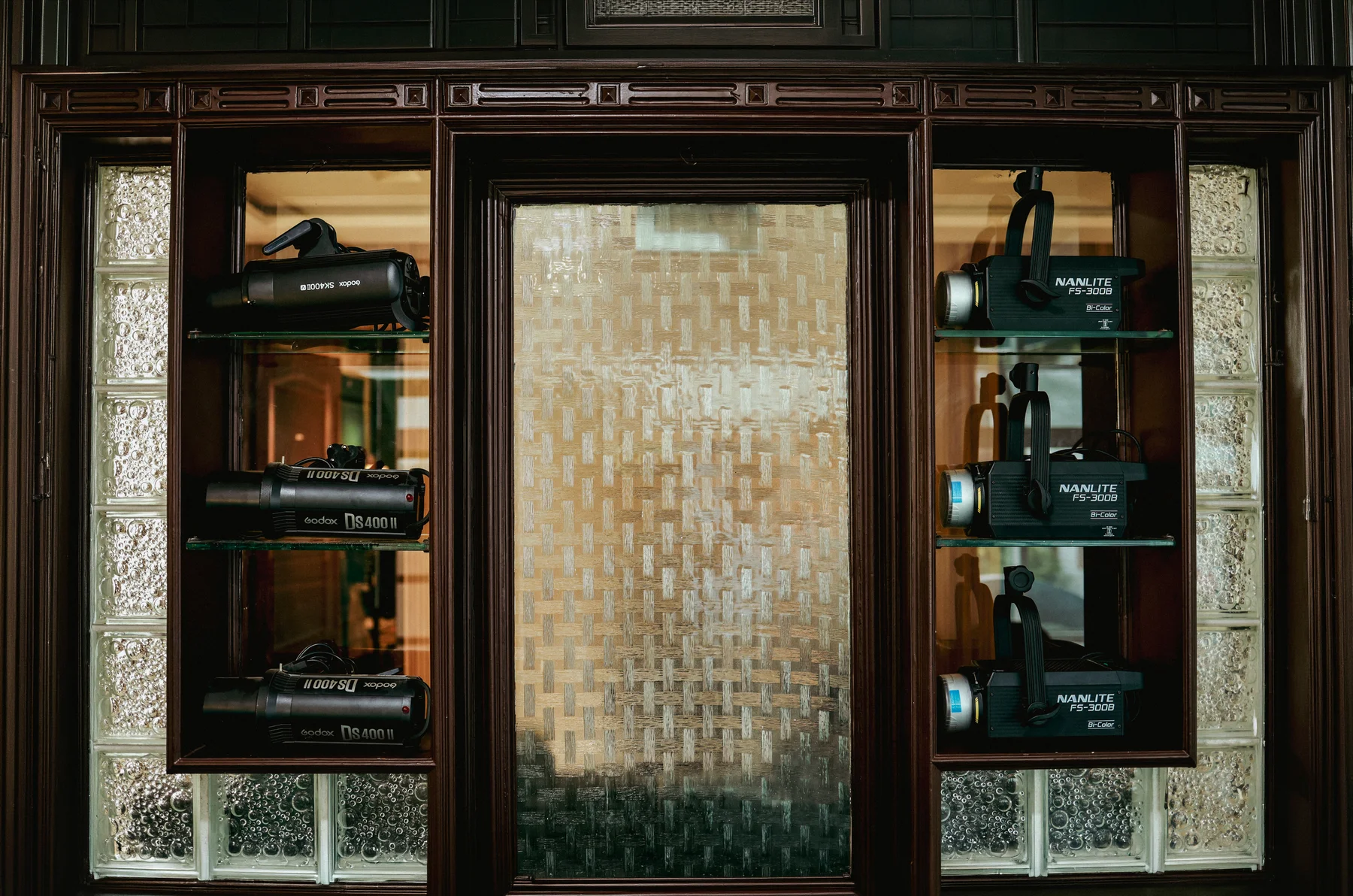 The glass-fronted equipment cabinet in the studio.