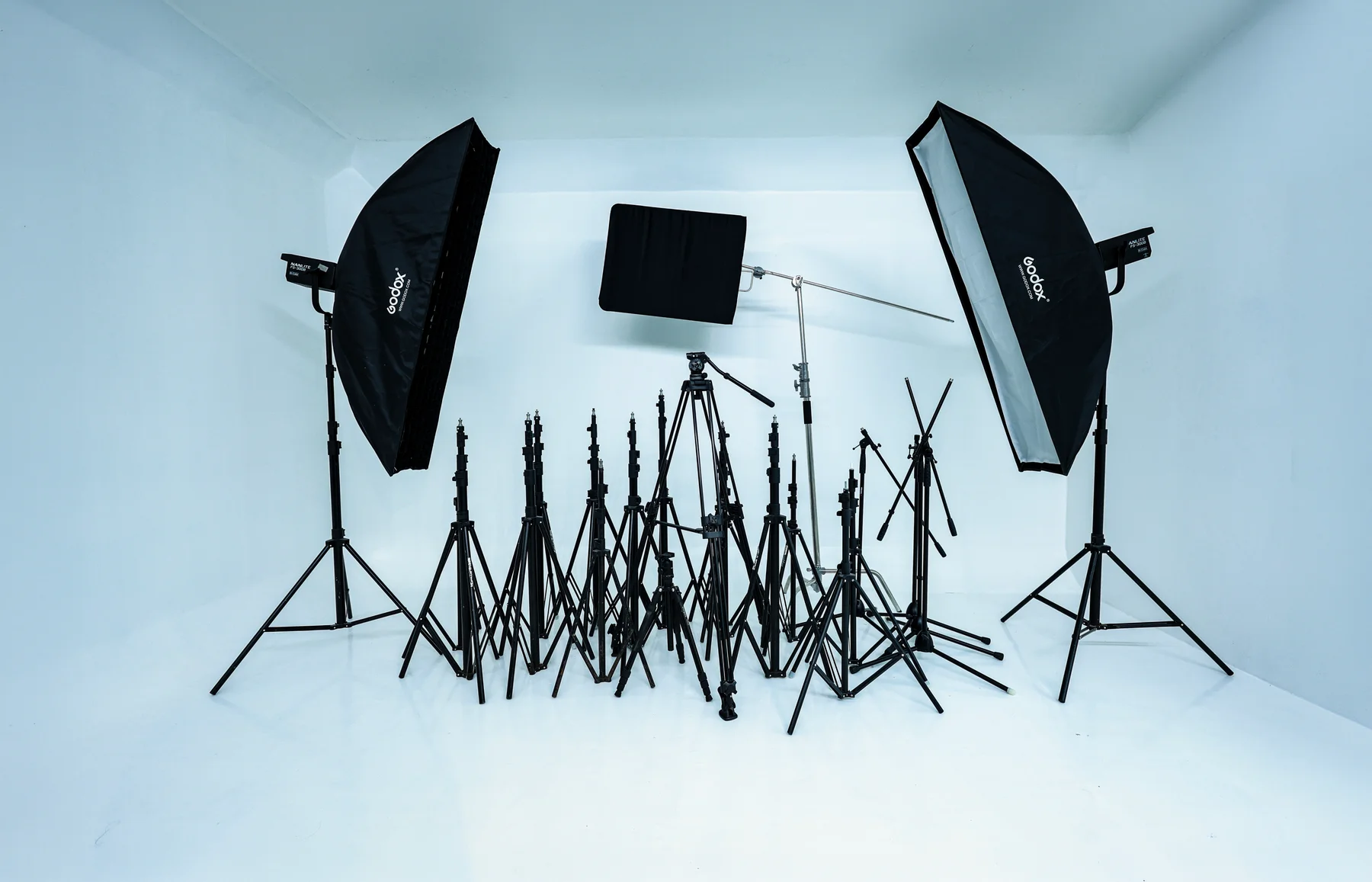 Softboxes, lighting modifiers and stands on the studio shooting floor